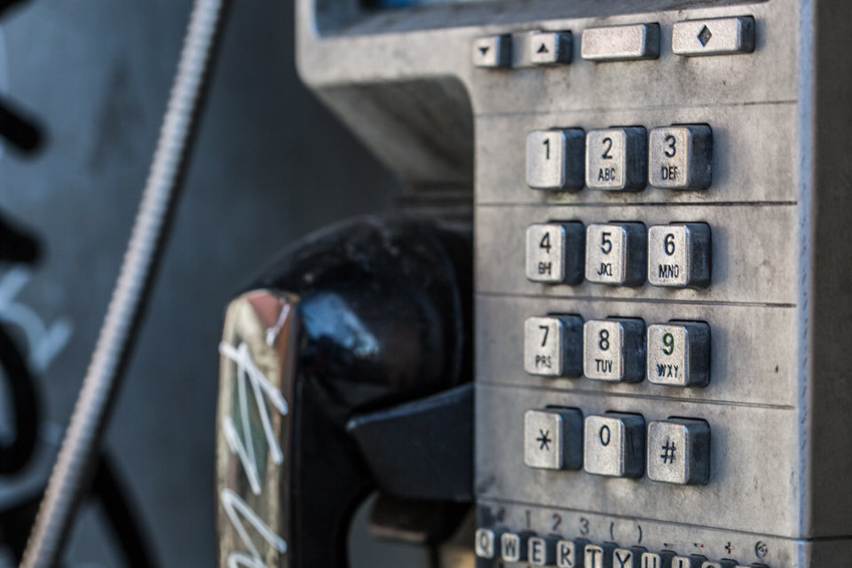 Close up image of the buttons of a payphone